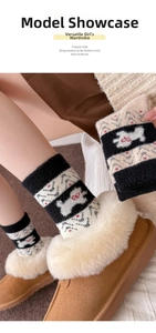 Detail von warmen Fair-Isle-Socken mit Hundemuster und flauschigen Winter-Loafern