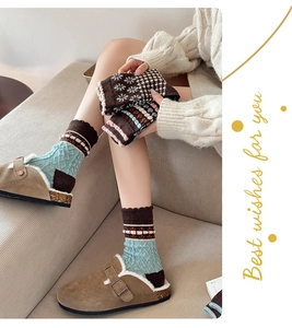 Close-up of thick vintage floral wool socks in brown tones with intricate ethnic patterns