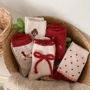Five pairs of red and beige wool socks with cute dog embroidery and bow accents