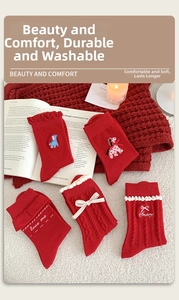 Detail of red festive cotton socks with cute horse embroidery and white bow accents