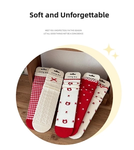 Detailed set of five red and cream knit socks with plaid, floral, and cat patterns