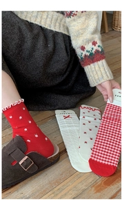 Detail of vintage red floral and checkered cotton socks with wavy ruffle cuffs