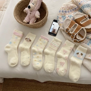Set of six pairs of thick thermal socks with cute puppy patterns in cream and beige colors