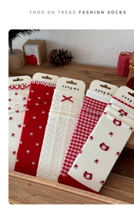 Detailed set of five red and white floral patterned cotton socks in a rustic gift box