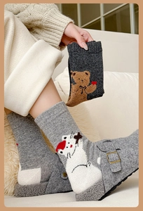 Detail of wool socks featuring cute 3D bear and cat embroidery for winter warmth