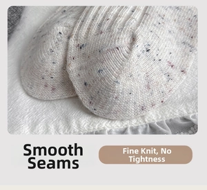 Detail shot of seamless toe stitching and flecked knit wool texture on calf socks