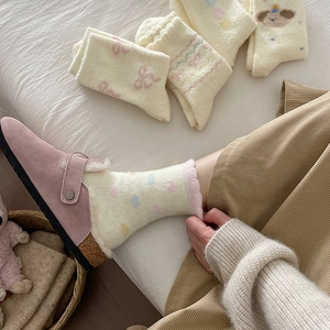Thick warm fleece socks with cute patterns paired with pink furry mule slippers at home