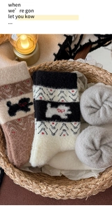 Detailaufnahme von dicken Fair-Isle-Thermosocken mit niedlichen Cartoon-Hundemustern