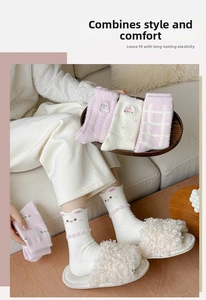 Detail of plush thermal socks with cute cat ears and embroidery for winter comfort