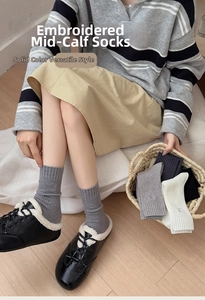 Detail of embroidered ribbed crew socks in assorted neutral colors for women