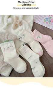 Close-up of fluffy thermal cat socks with pink heart pattern and happy text detail