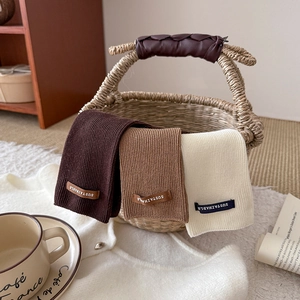 Three-color ribbed knit slouch socks with sustainable letter patch in lifestyle setting