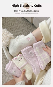 Close-up of cute pink cat embroidery and plush texture on warm winter fleece socks