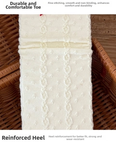 Detailed close-up of cream knit socks featuring reinforced heel and seamless toe design