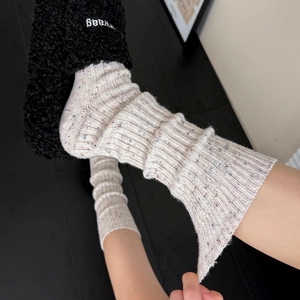 Thick wool calf socks with colorful flecks and ribbed knit texture in creamy white color