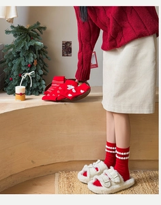 Festive red cotton mid-calf socks with heart patterns and stripes in a cozy winter setting
