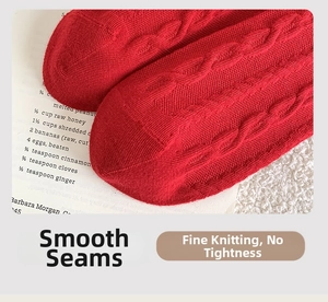 Close-up of the smooth toe seam and cable-knit texture on these red festive socks