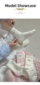 Detailed close-up of thick thermal fleece socks with cute cartoon smiley face and happy text