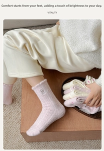 Detailed view of warm pink and beige coral fleece socks featuring cute animal embroidery
