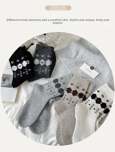 Detail of five pairs of wool blend argyle socks in warm autumn colors on soft background