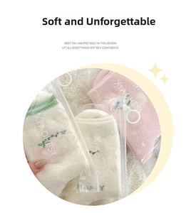 Close-up of thick cat-themed thermal fuzzy socks in multi-color zipper packaging