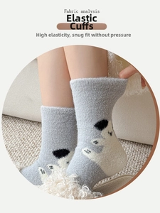 Close-up of high-elasticity cuff on thick grey thermal socks with polar bear pattern