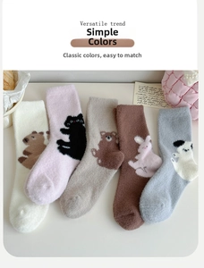 Flat lay of five pairs of plush thermal coral fleece socks with cute cartoon animal patterns