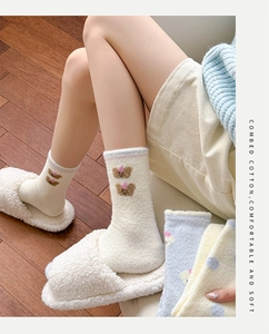 Detail of plush winter socks with cute bear embroidery and cozy combed cotton texture