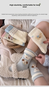 Detail showing high-stretch thick coral fleece socks with cute cartoon embroidery design