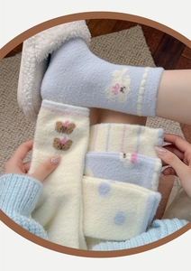 Thick velvet socks with cute cartoon embroidery showing soft fleece texture and patterns