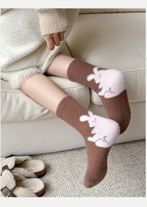 Close-up of thick thermal fleece socks with a cute white rabbit embroidery detail