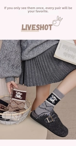 Detaillierte Nahaufnahme von Winterstricksocken mit süßen Bärenmustern und Rippbündchen