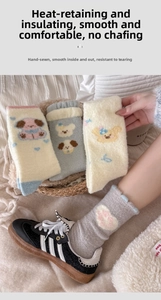 Detail of warm winter plush socks with cute dog patterns and thick ribbed cuffs