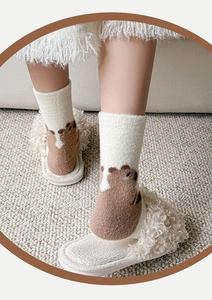 Detailed view of warm winter socks with cute cartoon bear pattern and soft ribbed cuffs