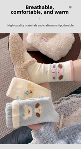 Detail of plush thermal socks with cute puppy patterns in soft macaron colors