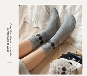 Detailed knit of thick wool socks with Nordic argyle pattern and ribbed cuffs for winter