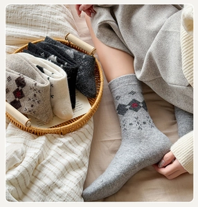 Detail of wool socks with vintage argyle and snowflake patterns in various colors