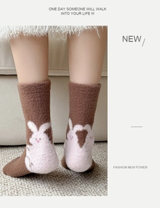 Detail of warm brown coral fleece socks with cute rabbit heart design on the heels