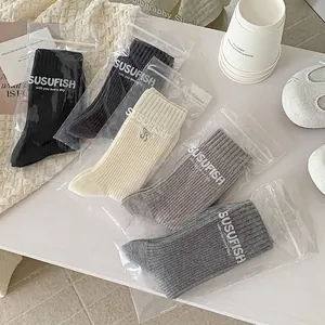 Five pairs of rib-knit mid-calf socks with bow embroidery in soft neutral color tones