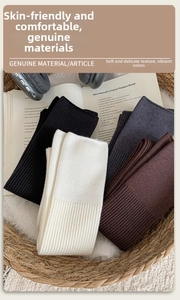 Detailed texture of rib-knitted cashmere socks in neutral colors arranged in a basket