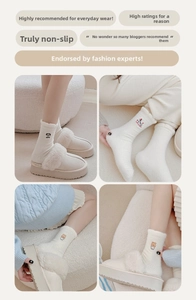 Detail view of warm knit socks with cute animal embroidery and plush slippers