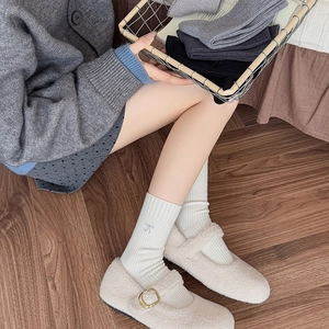 White crew socks for women featuring elegant bow embroidery and a soft ribbed knit texture