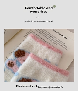 Detail of elastic cuff on thermal fleece socks with cute cartoon paw patterns