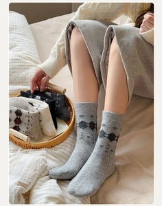 Close-up of thick Argyle wool socks with snowflake patterns and ribbed cuffs