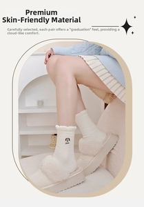 Detail of warm winter fluffy socks with puppy embroidery and plush slipper texture
