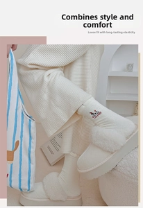Detail of warm white fleece sock with cute puppy embroidery and plush texture