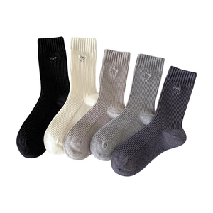 Five pairs of ribbed cotton mid-calf socks with delicate bow embroidery in neutral tones