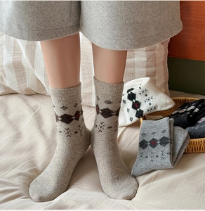 Detail of vintage argyle wool socks in various colors with Nordic snowflake patterns