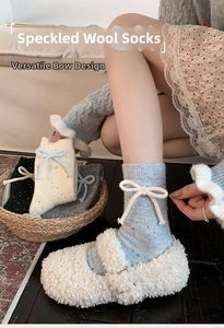 Detail of wool socks with bow decoration and colorful speckled knit texture