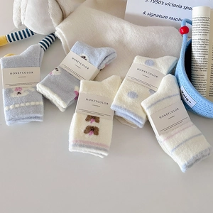Five pairs of thick thermal socks with cute cartoon bear patterns and fuzzy texture